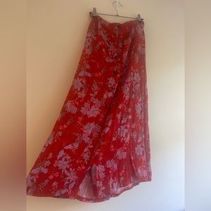 stunning Chelsea and Theodore breezy  red skirt adorned with charming flowers.